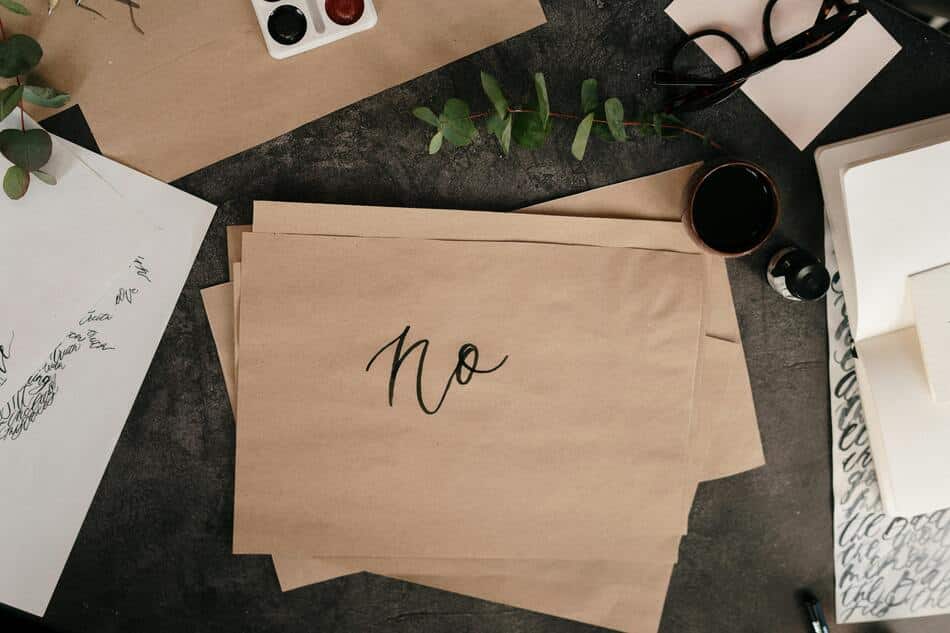 A brown paper on a table with the word 'no' written on it.